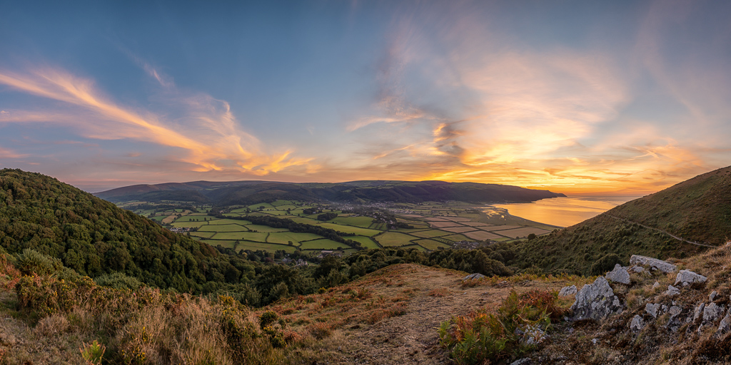 Colourful sunset across Porlock Marsh and Bossington Beach from Bossington Hill after the sun set behind Forleland Point, Exmoor National Park